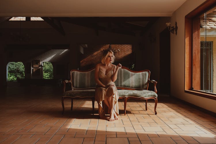 Woman In Dress Posing On Couch