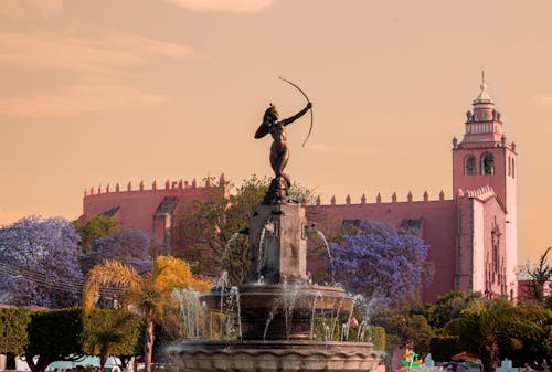 Archer Sculpture on Fountain and Colorful Trees behind in Dolores Hidalgo in Mexico