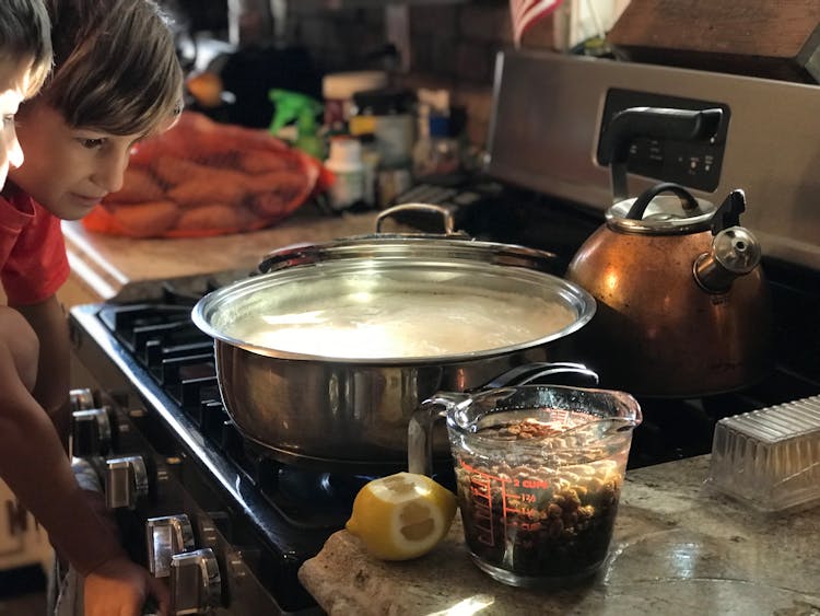 Boy Face Near Pot In Kitchen