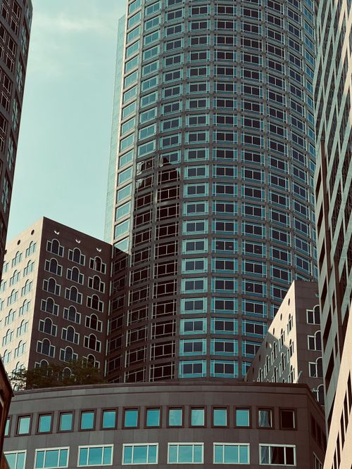 Free Capturing the sleek lines of modern skyscrapers against a clear sky. Stock Photo