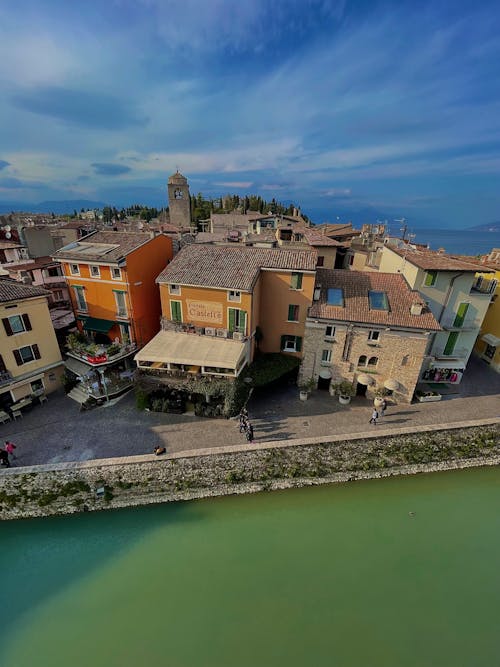 Aerial Footage of a Town Roofs by a Green River