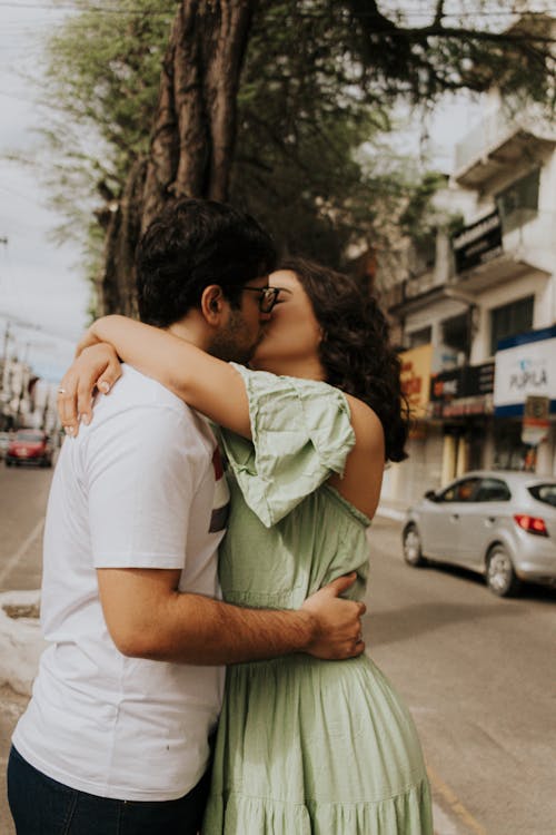 Side View of a Couple Kissing on a Street