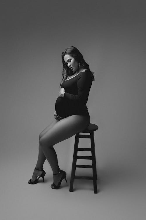 Pregnant Woman Posing on Stool in Studio