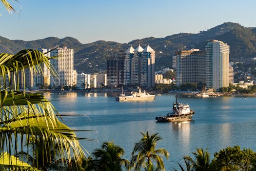 Scenic view of Acapulco's urban skyline and harbor with ships amidst lush palm trees.