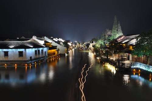 Free Houses Near a Body of Water during Nigh Time Stock Photo