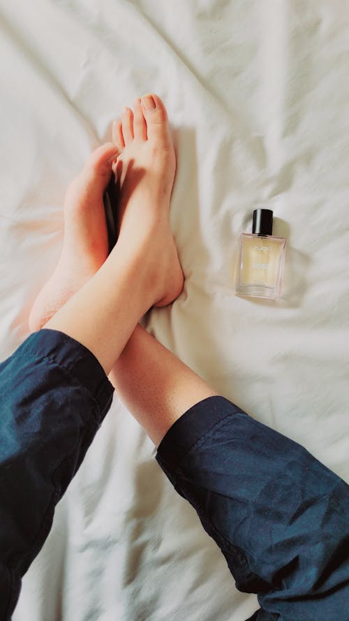 Woman Feet and Perfume Vial