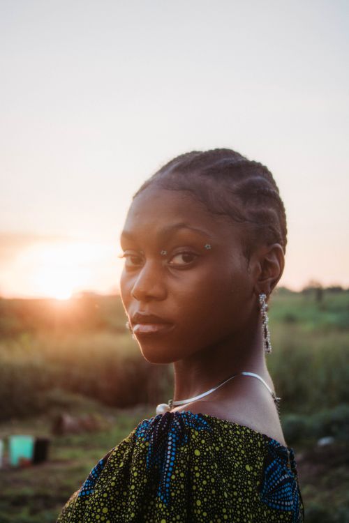 Young Woman Posing Outside at Sunset · Free Stock Photo