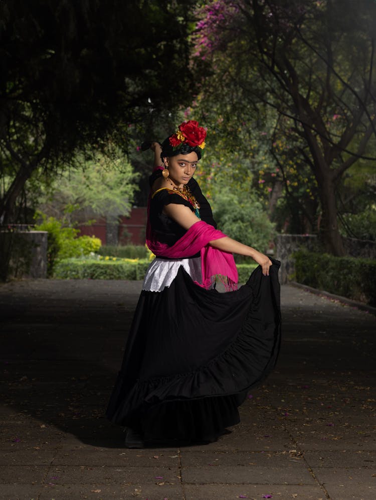 Young Woman In Traditional Dress Posing In Park