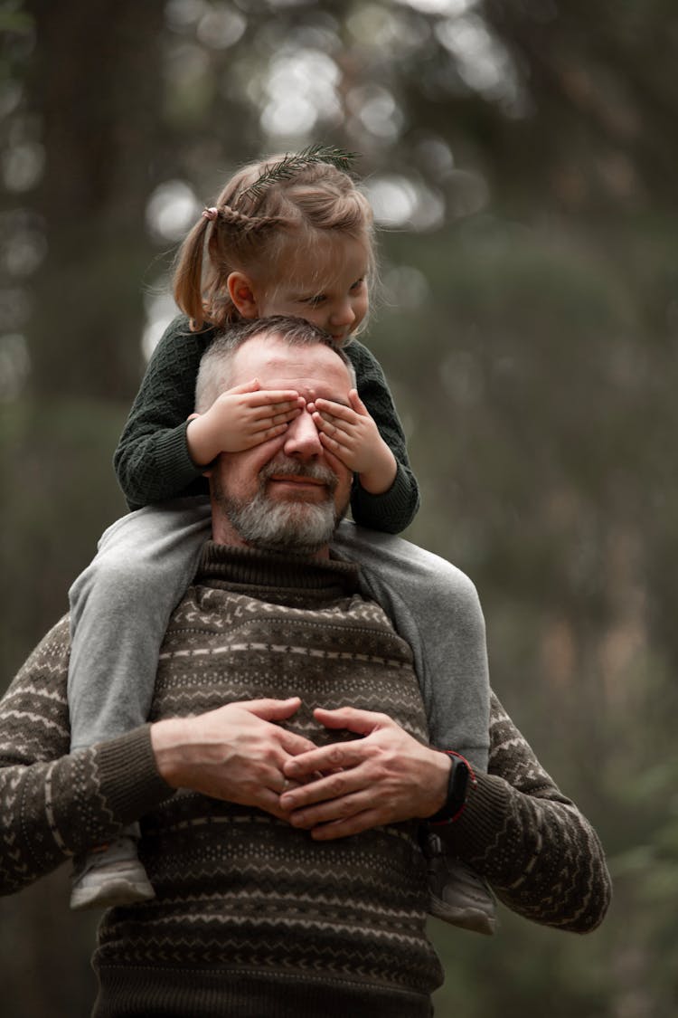 A Portrait Of Father And A Daughter In Forest