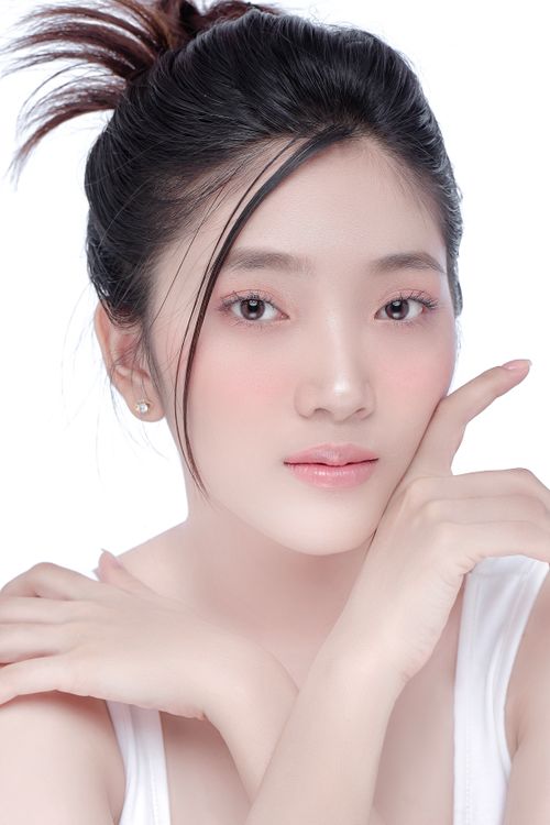 Free Close-up portrait of a young woman with natural makeup on a white background. Stock Photo