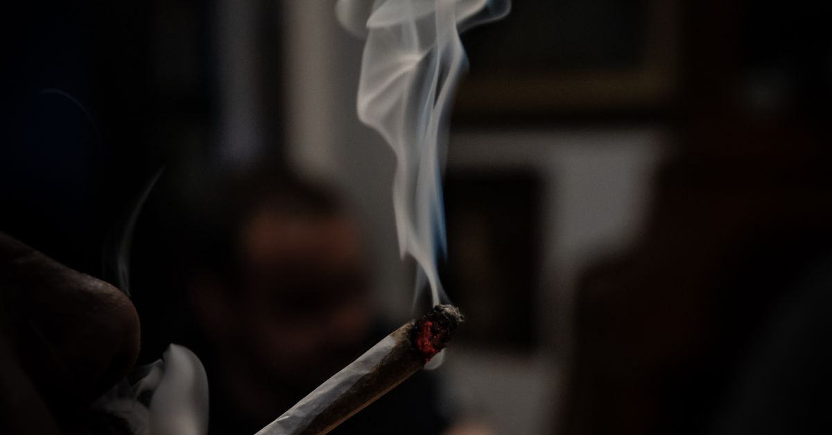 Close-up of Person Smoking Cigarette in Dark · Free Stock Photo