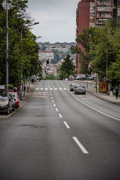 Free A city street with buildings and cars, showcasing an urban environment. Stock Photo