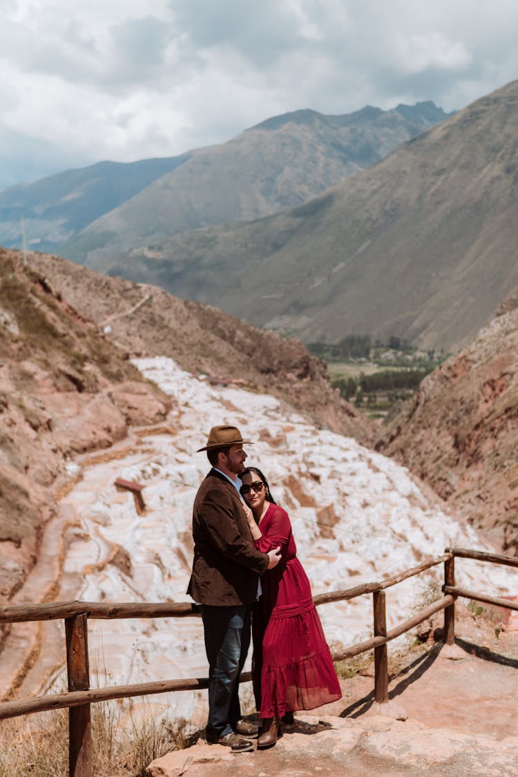 Elegant Man And Woman Standing At The Lookout Point In Mountains 