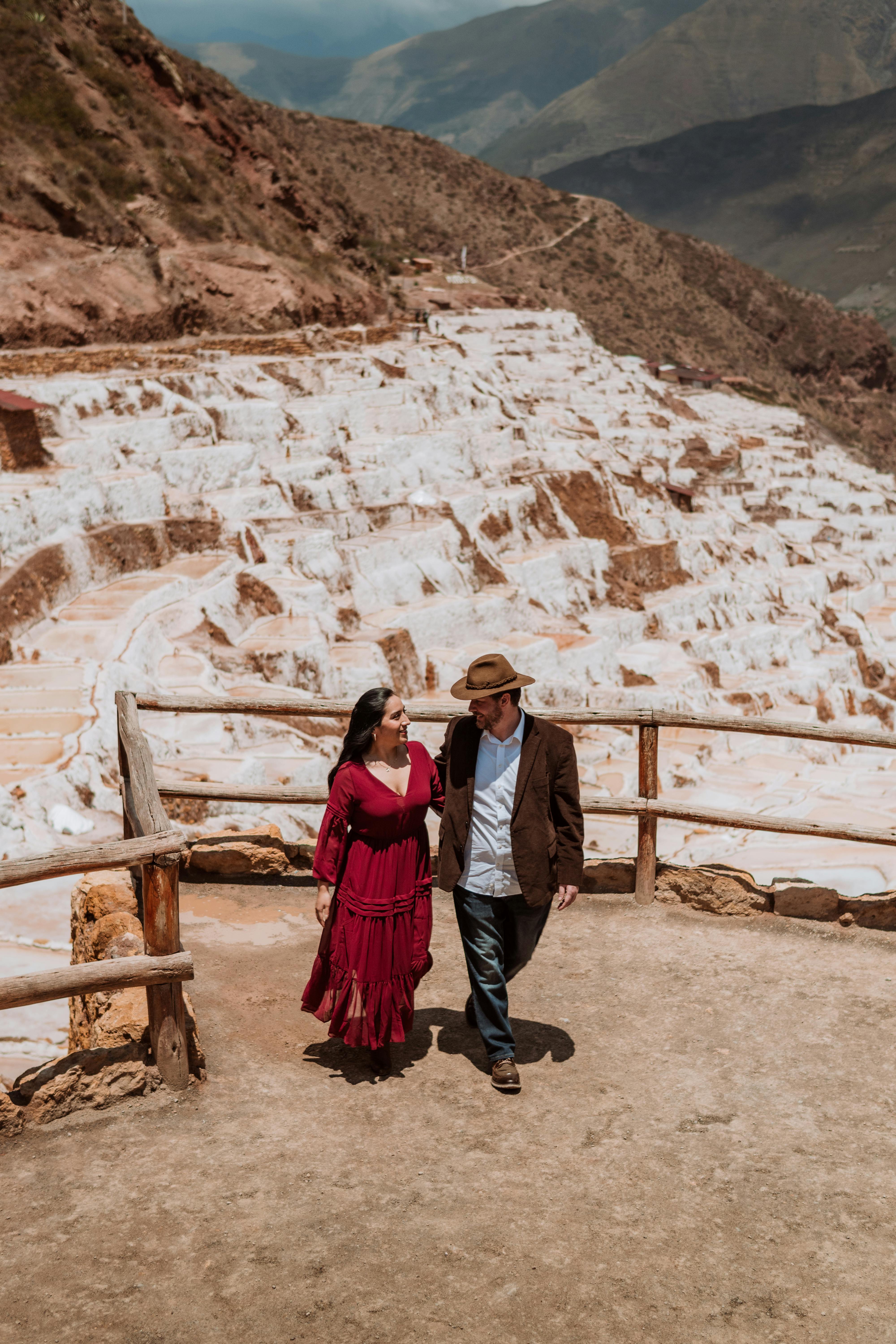 A couple enjoying a summer day walk at Maras salt mines, Peru.