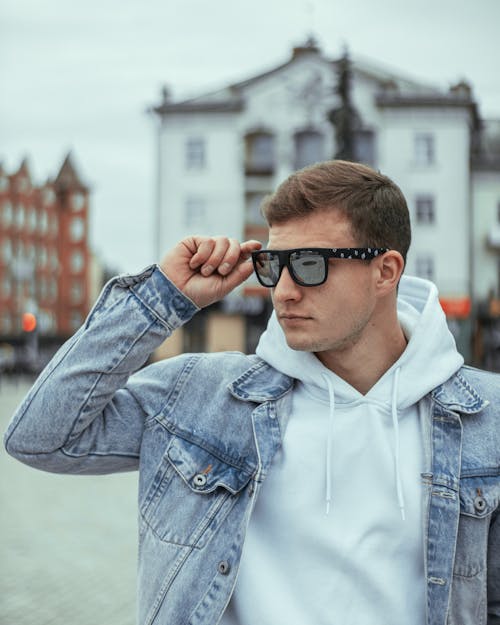 Man in a White Hoodie and a Denim Jacket 