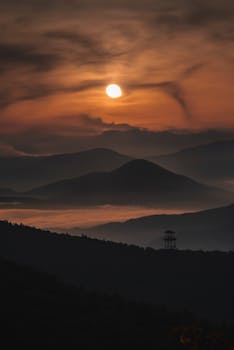 Silhouette of rolling hills with a dramatic sunset and scenic view.