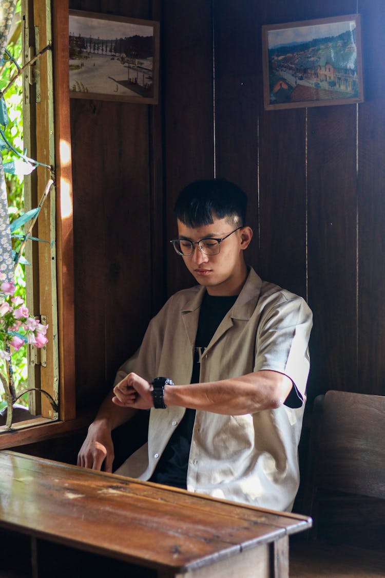 Man Checking Time On Wristwatch