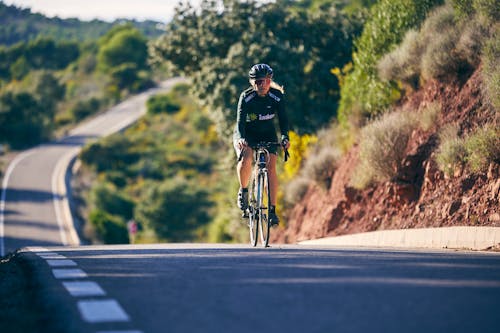 Woman on Road Bike on Hill