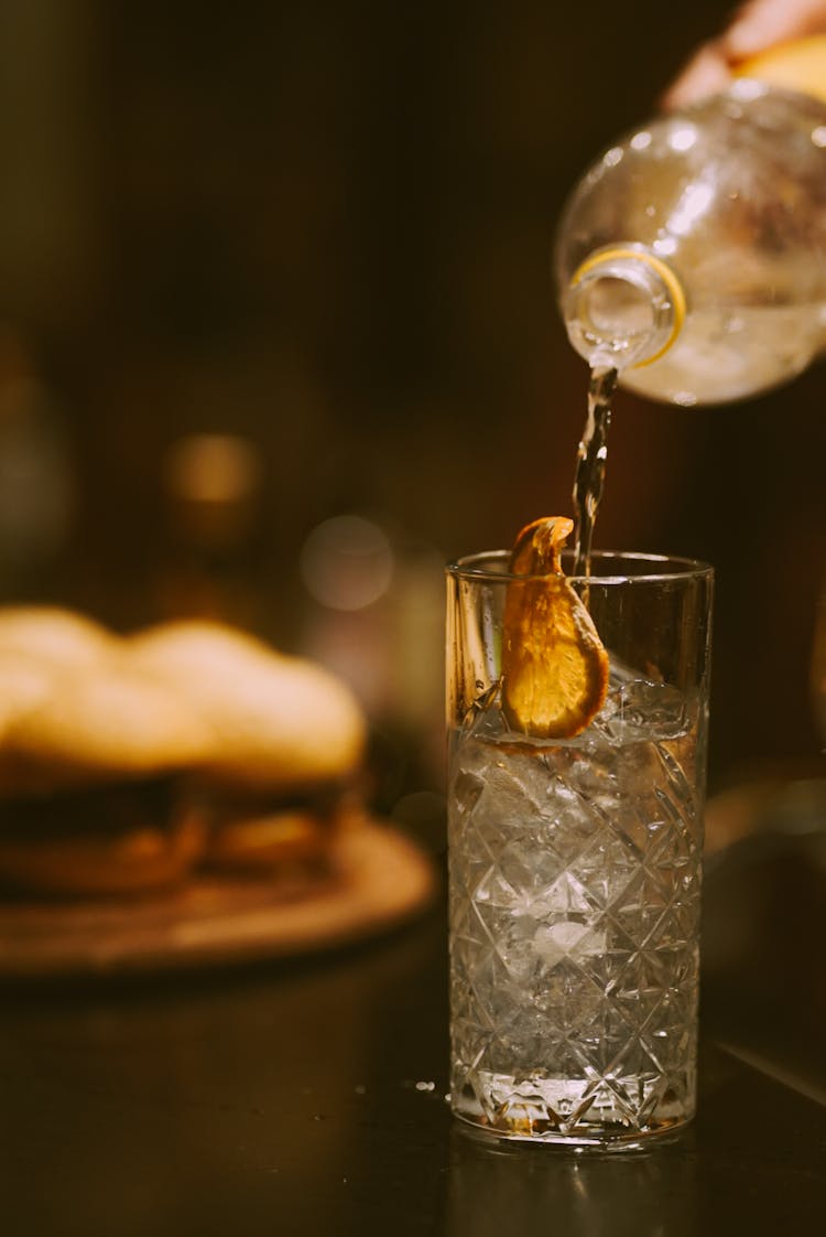 Pouring Alcohol To Glass With Ice