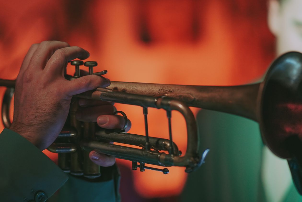 Musician playing trumpet in atmospheric stage light