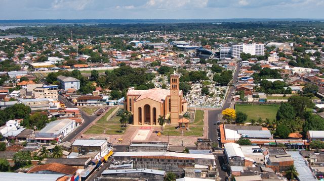 Aerial shot of Parintins, Brazil highlighting the prominent church in a bustling urban landscape.