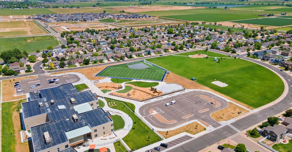 Aerial view of a town in Johnstown, CO, featuring a sports complex and residential area.