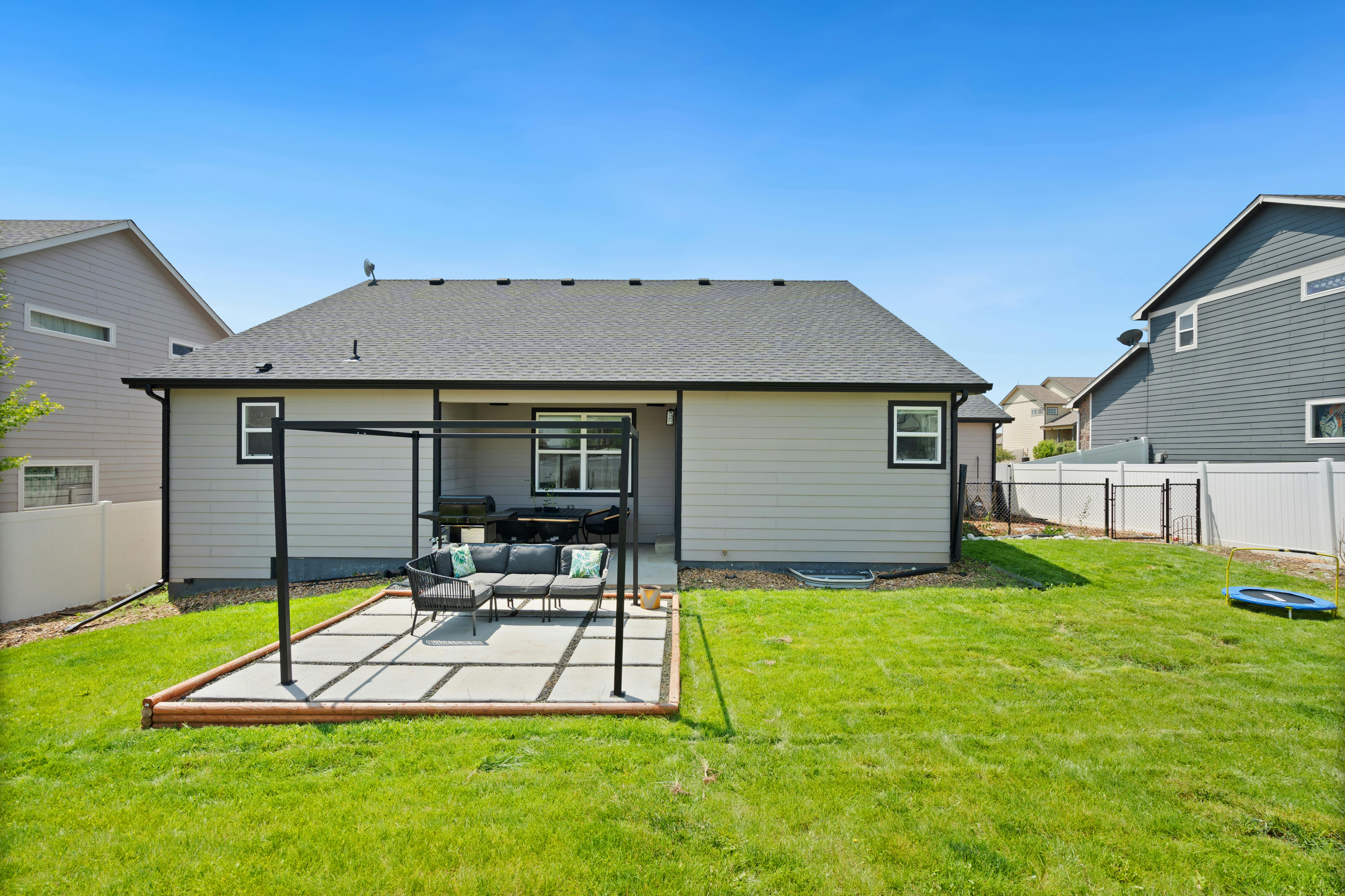 A modern home with a well-designed backyard patio and outdoor seating