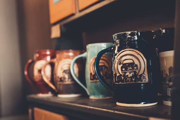 Stoneware mugs on a workbench — photo by Craig Adderley on Pexels