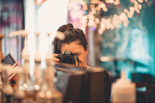 Selective Focus Photography Of Woman Holding Dslr Camera