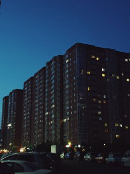 High-rise apartments in the city under a twilight sky, showcasing urban living.
