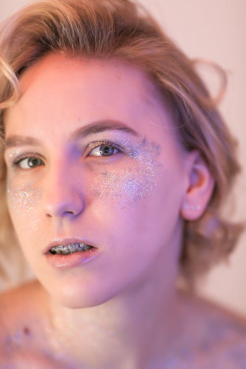 Portrait of Blonde Woman with Glitter on Face
