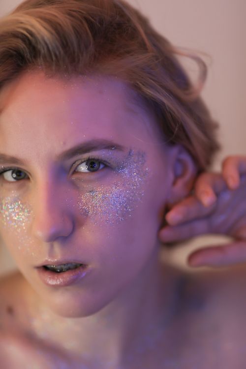Free Artistic portrait of a woman with glitter makeup, showcasing creativity and modern beauty trends. Stock Photo