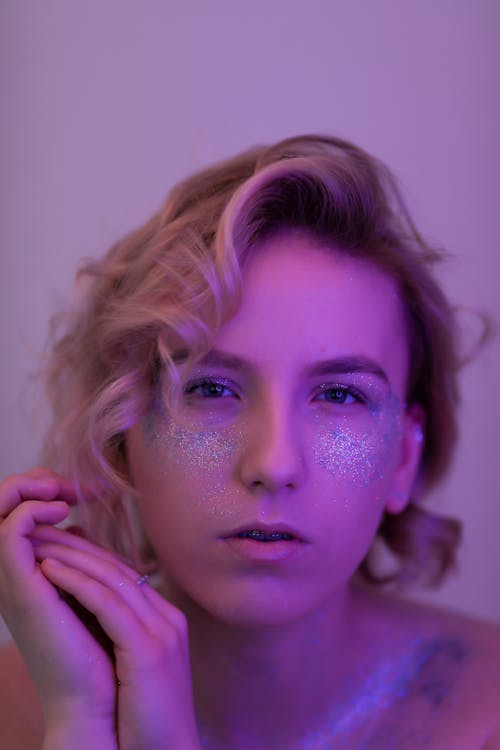 Portrait of Young Woman with Glitter on Face