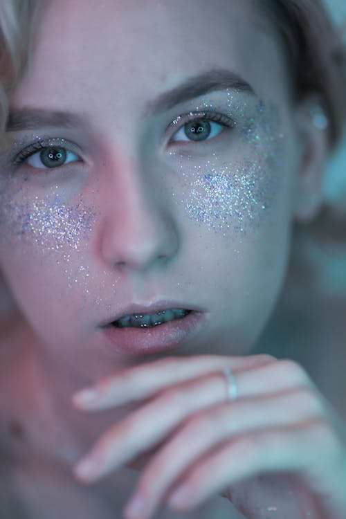 Portrait of Young Woman with Glitter on Face