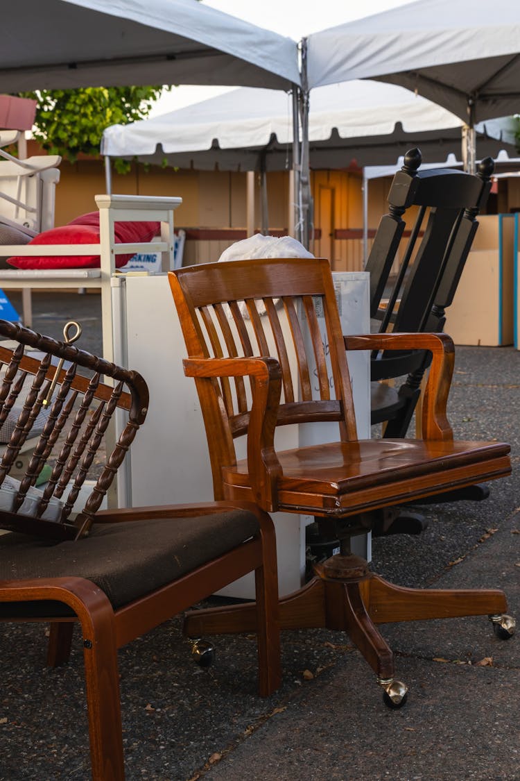 A Pile Of Old Wooden Furniture Outside 