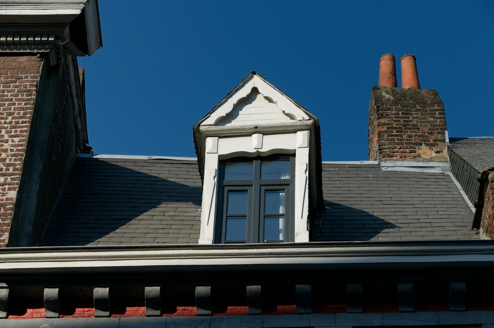 Attic Window and a Chimney, Low Angle View