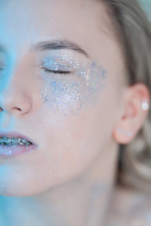 Young Woman with Braces with Glitter on Face