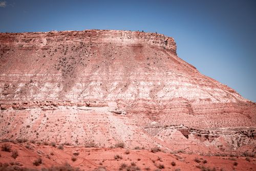 Free A striking red rock formation captures the beauty of desert erosion and geology under a clear sky. Stock Photo