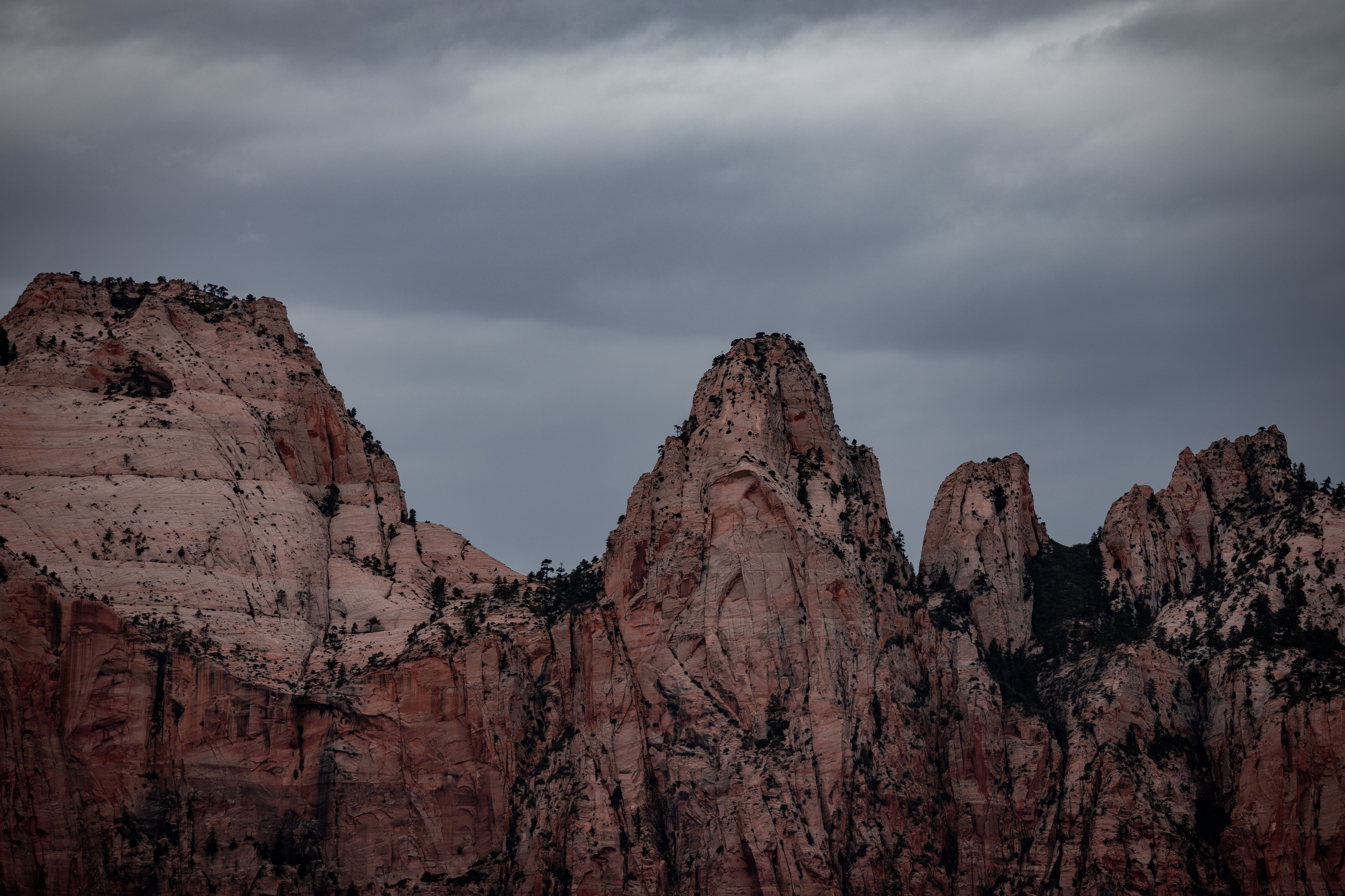 Towering rocky peaks under a moody sky at Zion National Park, Utah.