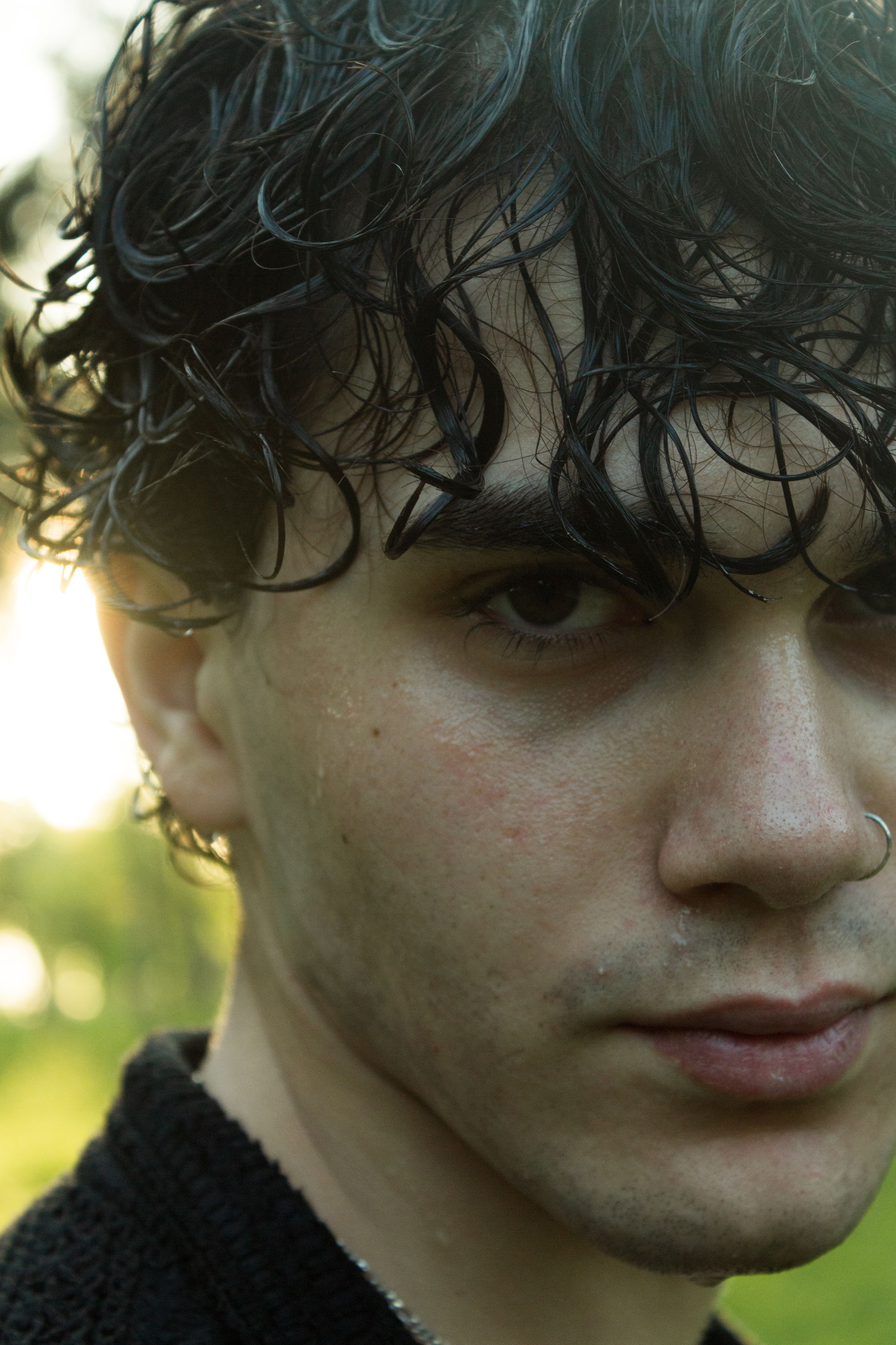 Portrait of Young Man with Curly Hair in Nature · Free Stock Photo