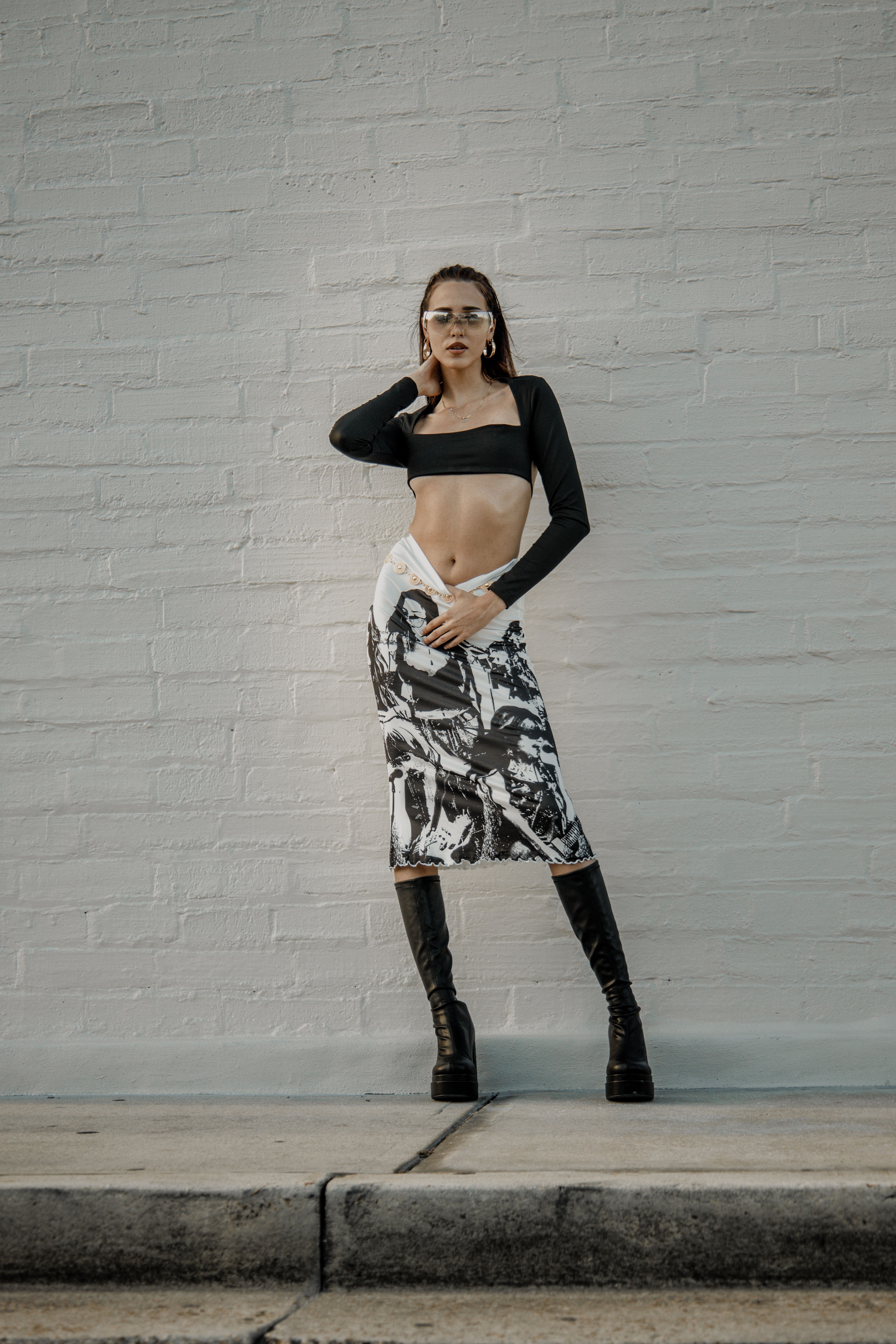 A woman in a crop top and skirt posing for a photo · Free Stock Photo