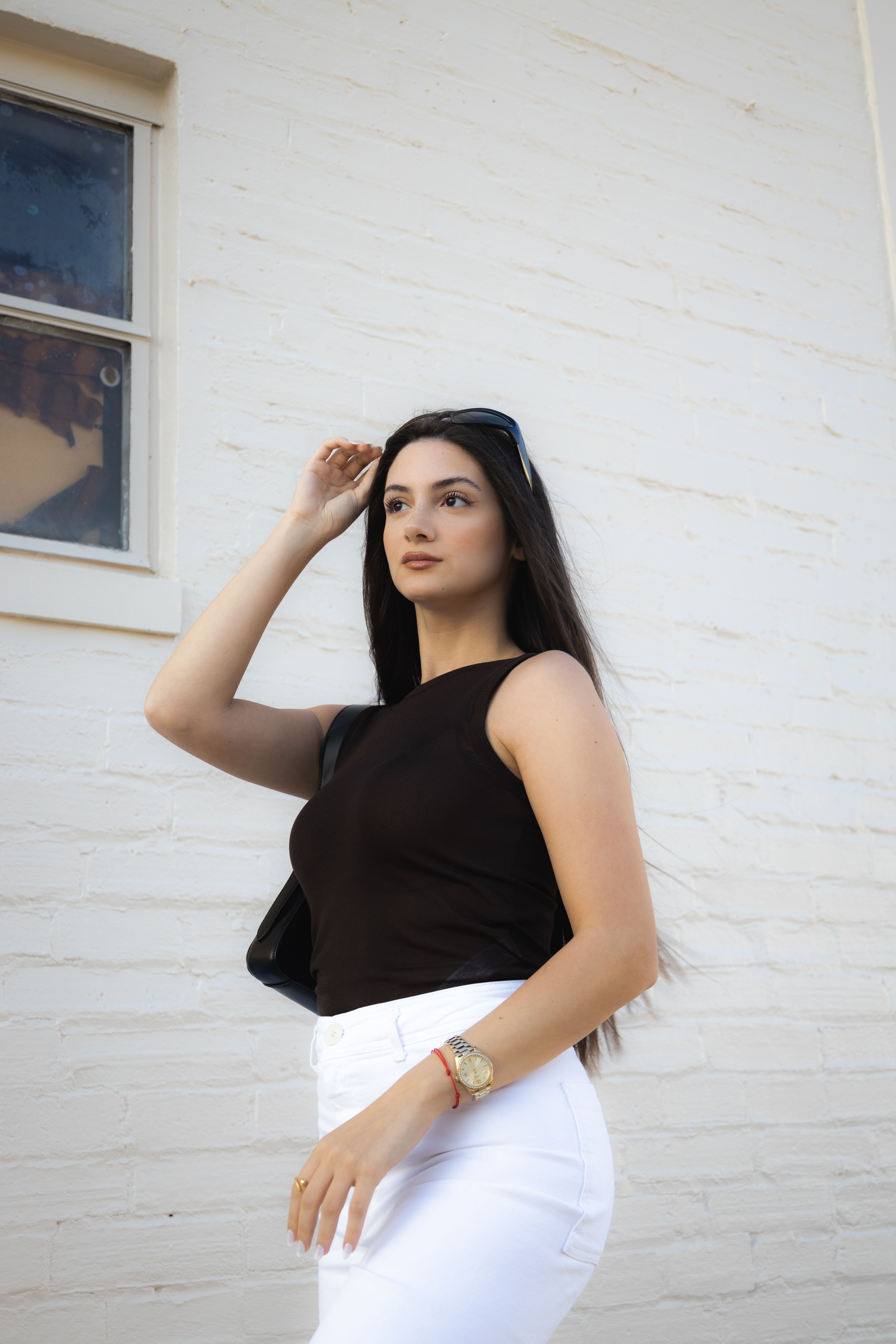 A woman in white pants and a black top · Free Stock Photo