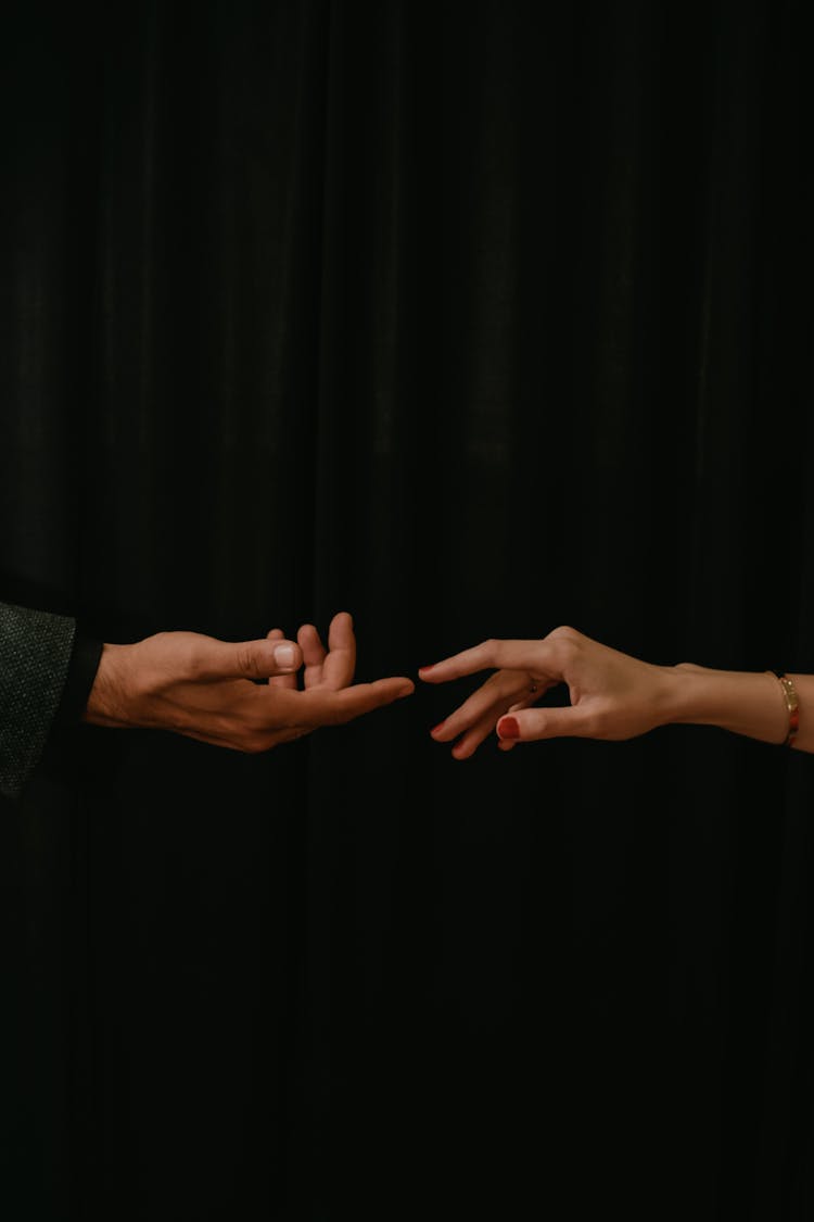 Hands Of Man And Woman Reaching For Each Other 