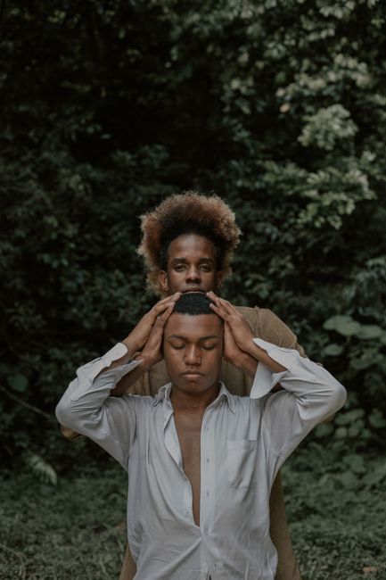 A calming portrait of two men in a lush forest setting, embracing mindfulness and connection.