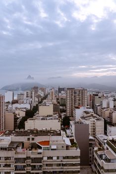 Stunning aerial view of Rio de Janeiro's cityscape showcasing urban architecture beneath cloudy skies.