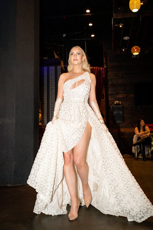 Young Woman in an Elegant White Dress at the Fashion Show 