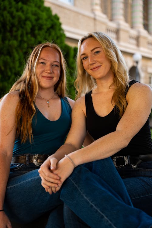 Smiling Blonde Women Sitting and Posing Together