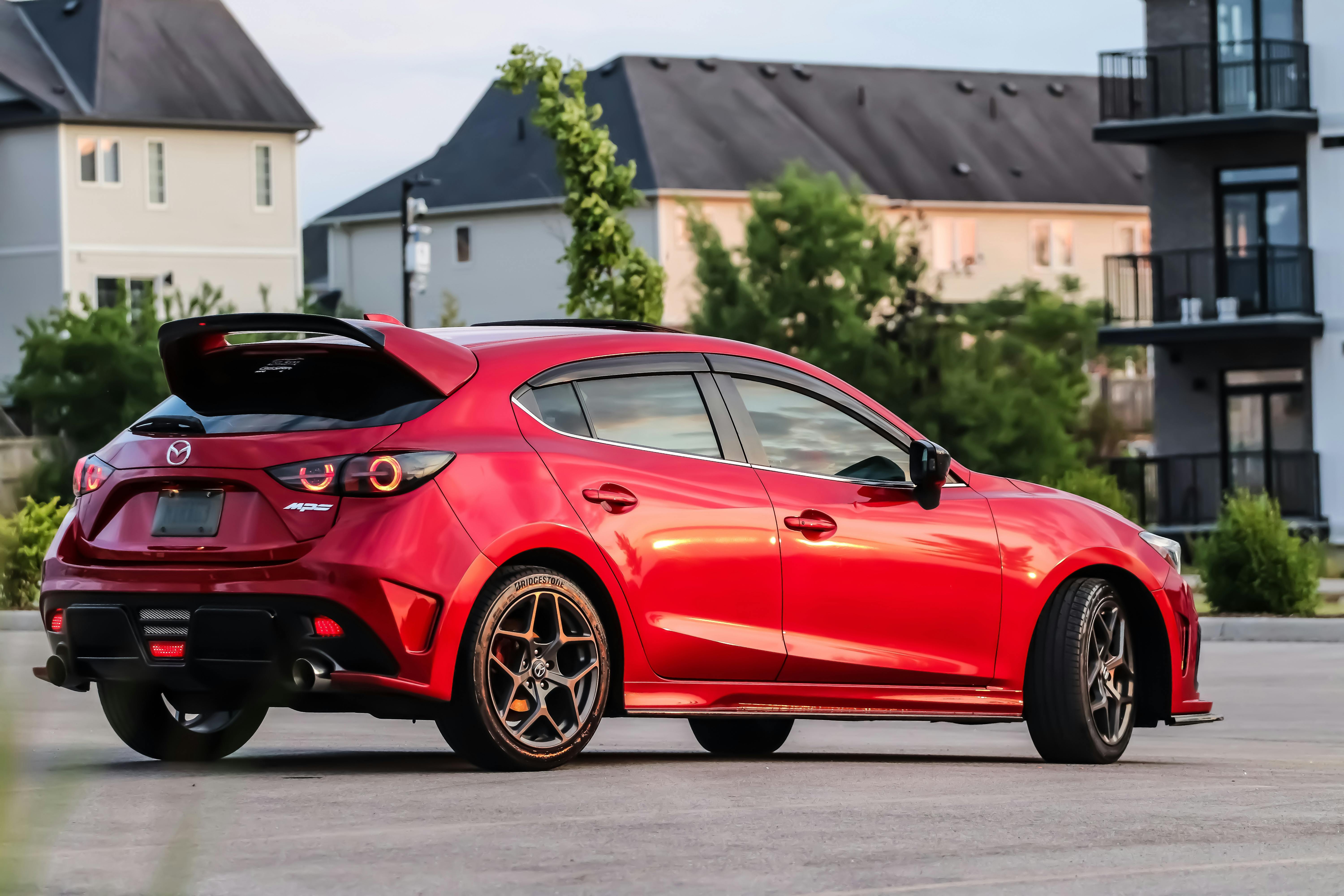 Back view of red mazda 3 free stock photo