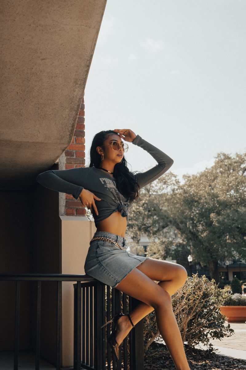 A woman in a crop top and jeans is posing for a photo · Free Stock Photo