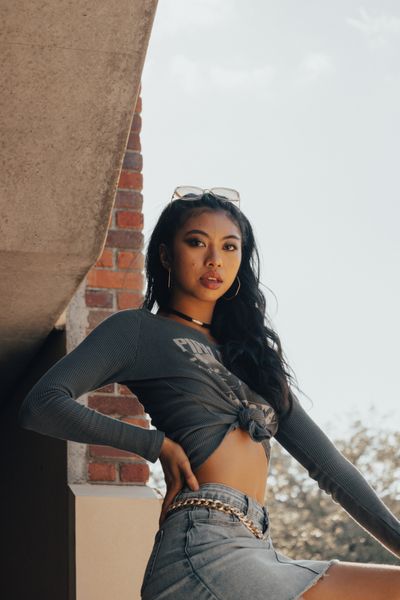 A woman in a crop top and jeans is posing for a photo · Free Stock Photo